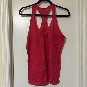Magenta Nike tank. Loose fit. Size medium. No rips holes stains.